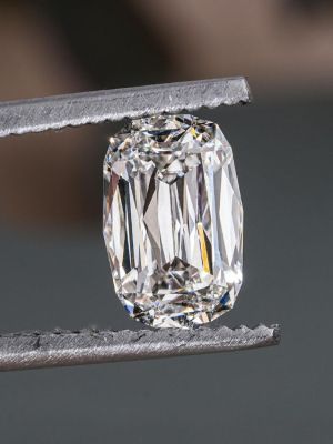 Close up of pliers holding a diamond