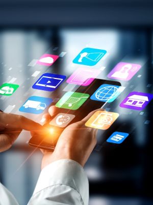 Close up of a person holding a phone and app images hovering around it to represent a tech stack